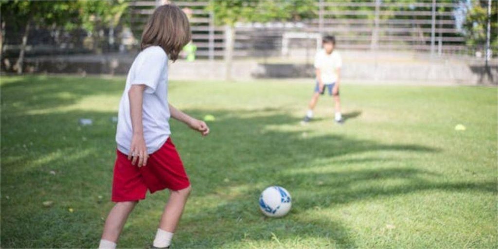 Playing football in the shade